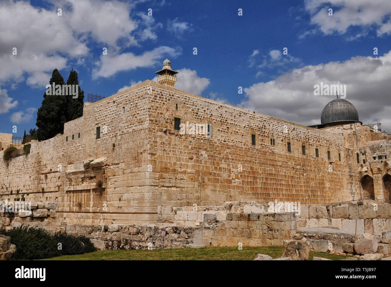 Wall around old city of Jerusalem including Robinson's arch and Al Aqusa Mosque dome Stock Photo