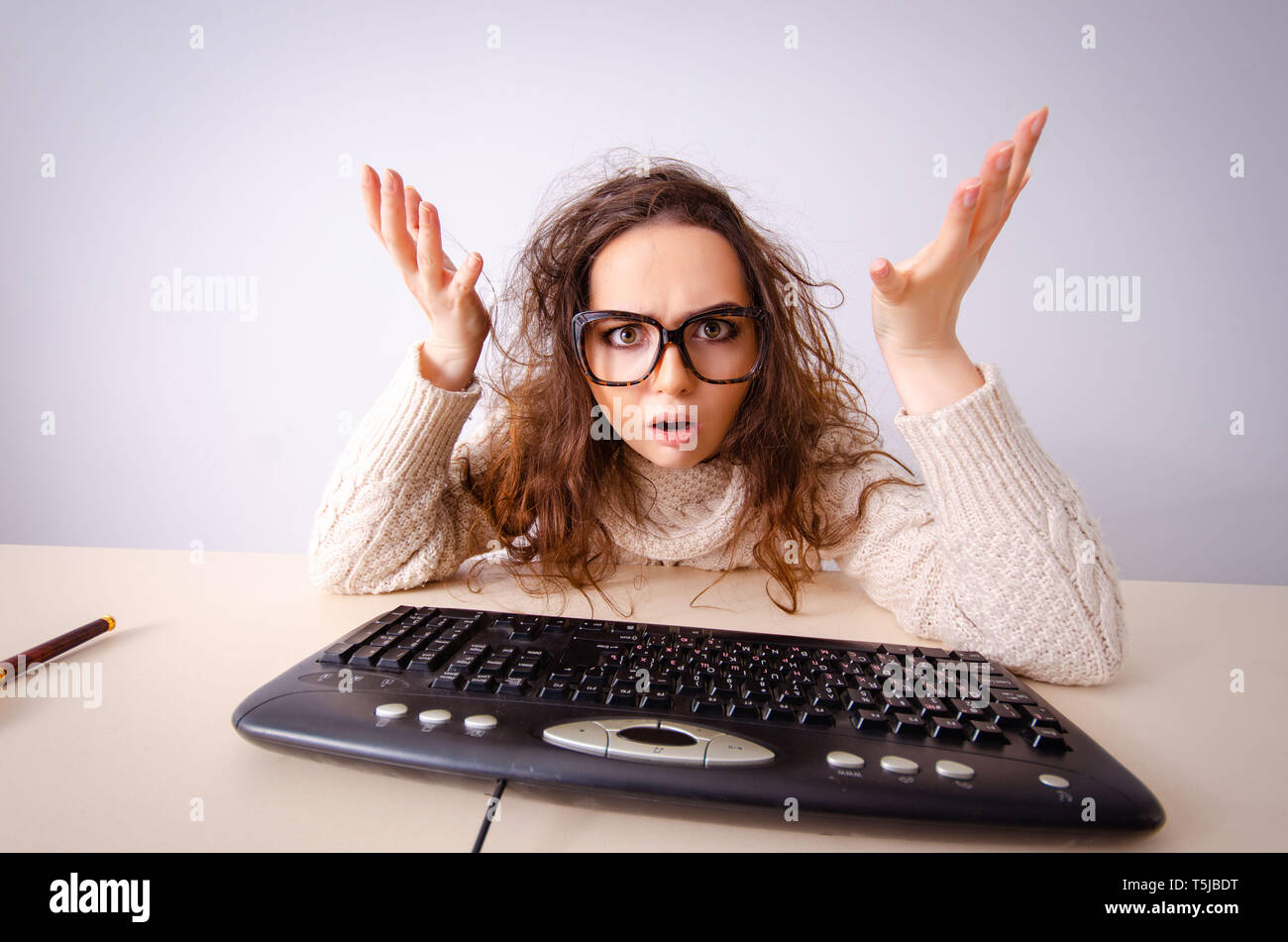 Funny nerd girl working on computer Stock Photo