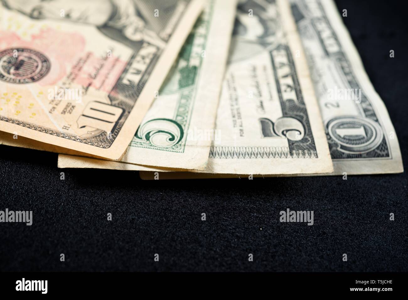 Dollar bills on a black table. Stock Photo