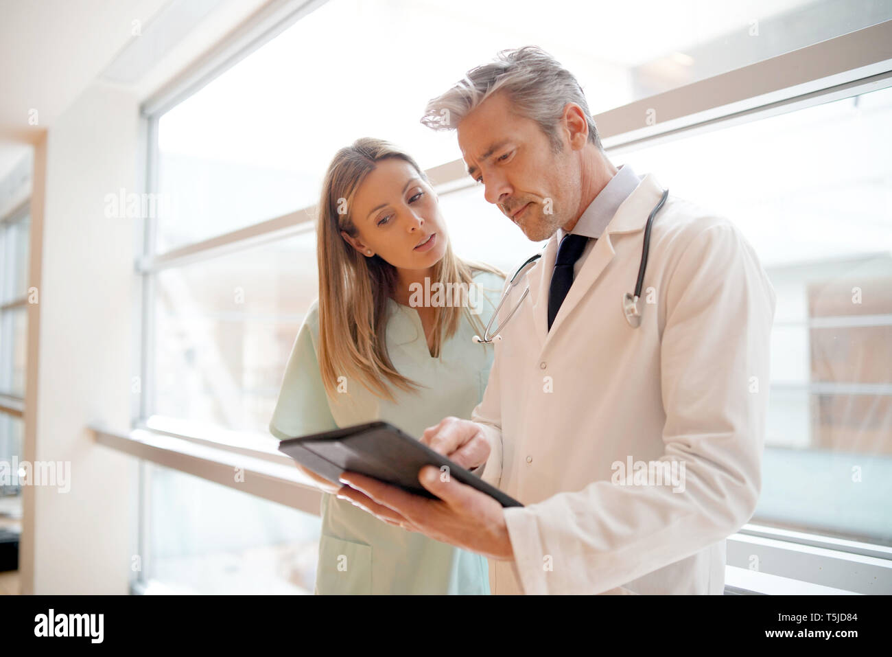 Nurse and doctor going over patient's results in hospital Stock Photo ...