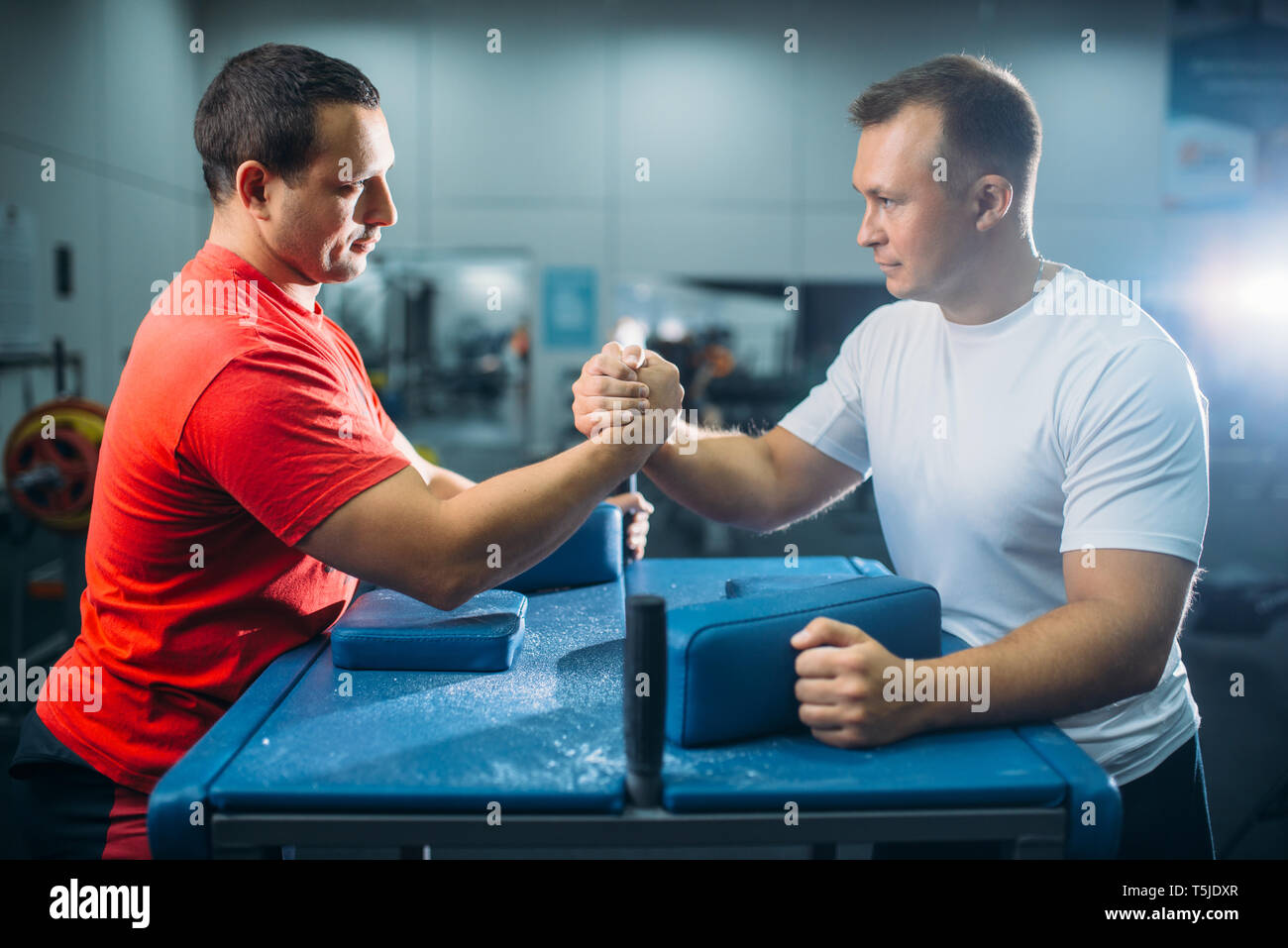 Two arm wrestlers prepares for the battle at the table with pins