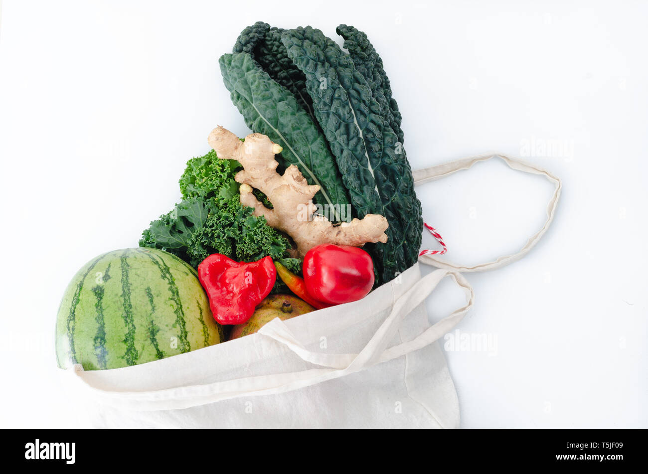 Ecological cloth bag with vegetables on white background. Top view. Stock Photo