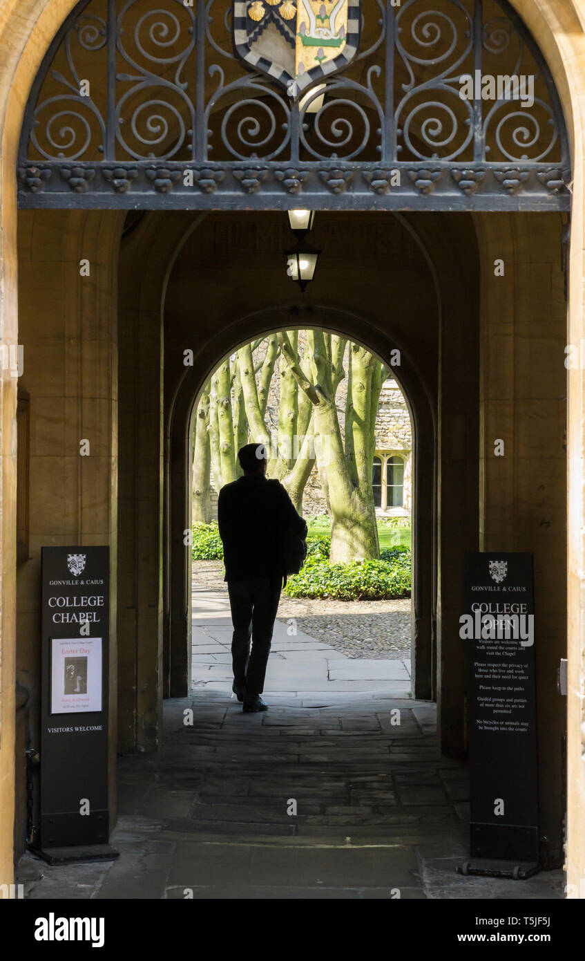 person sillhouetted in doorway to Gonville & Caius collge Cambridge Stock Photo