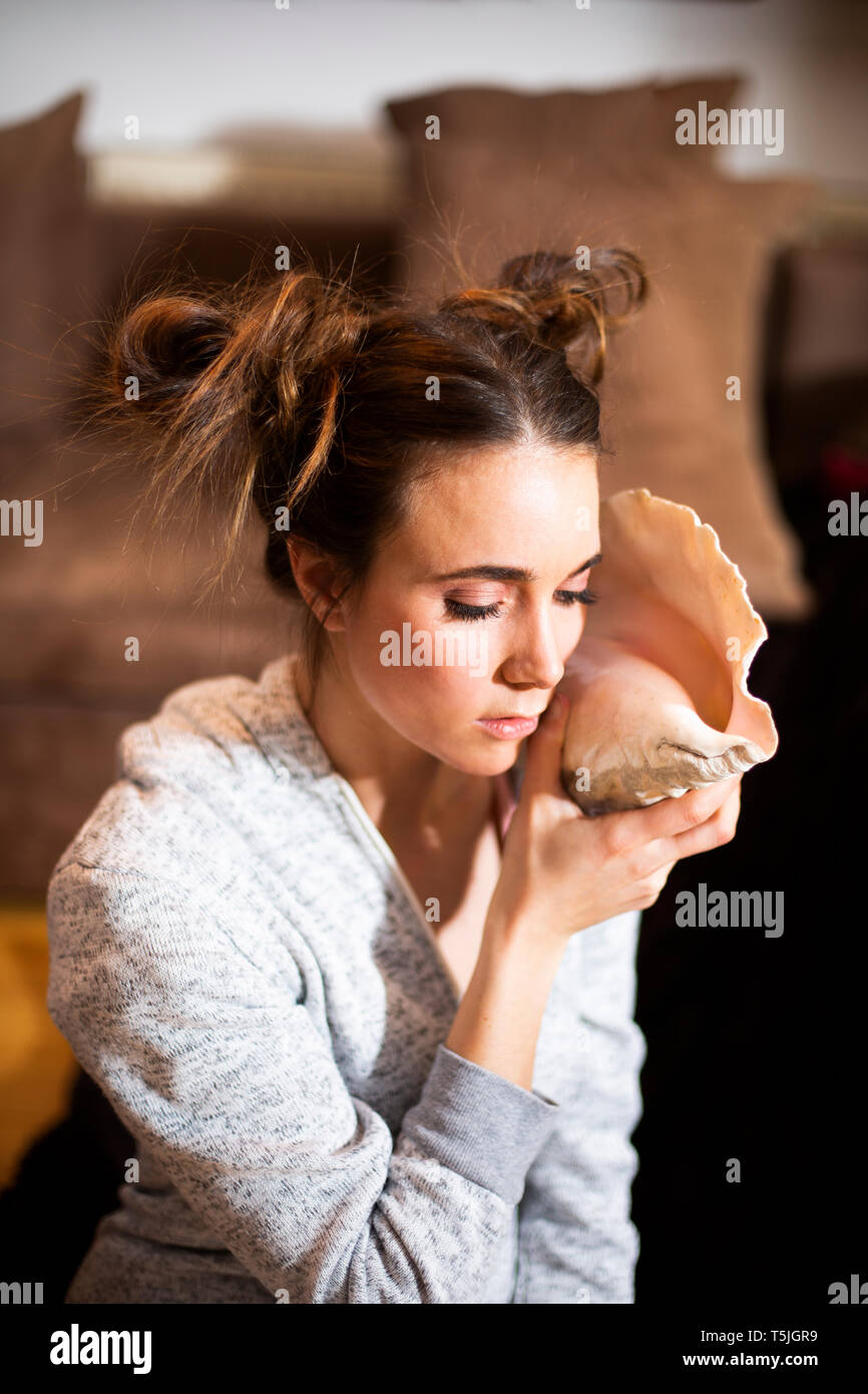 Portrait of young woman with big shell Stock Photo