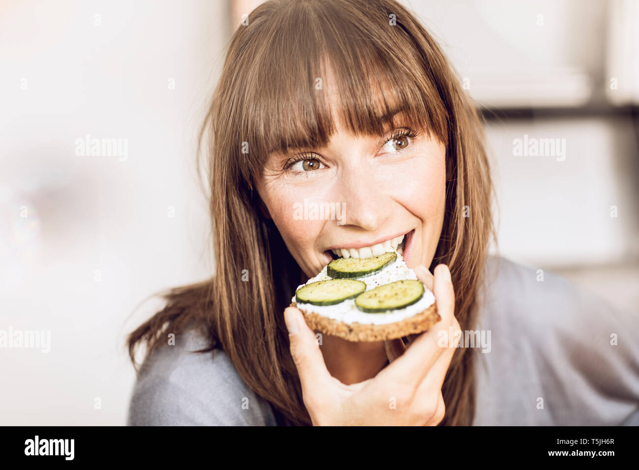 Mature woman eating healthy cucumber bread Stock Photo Alamy