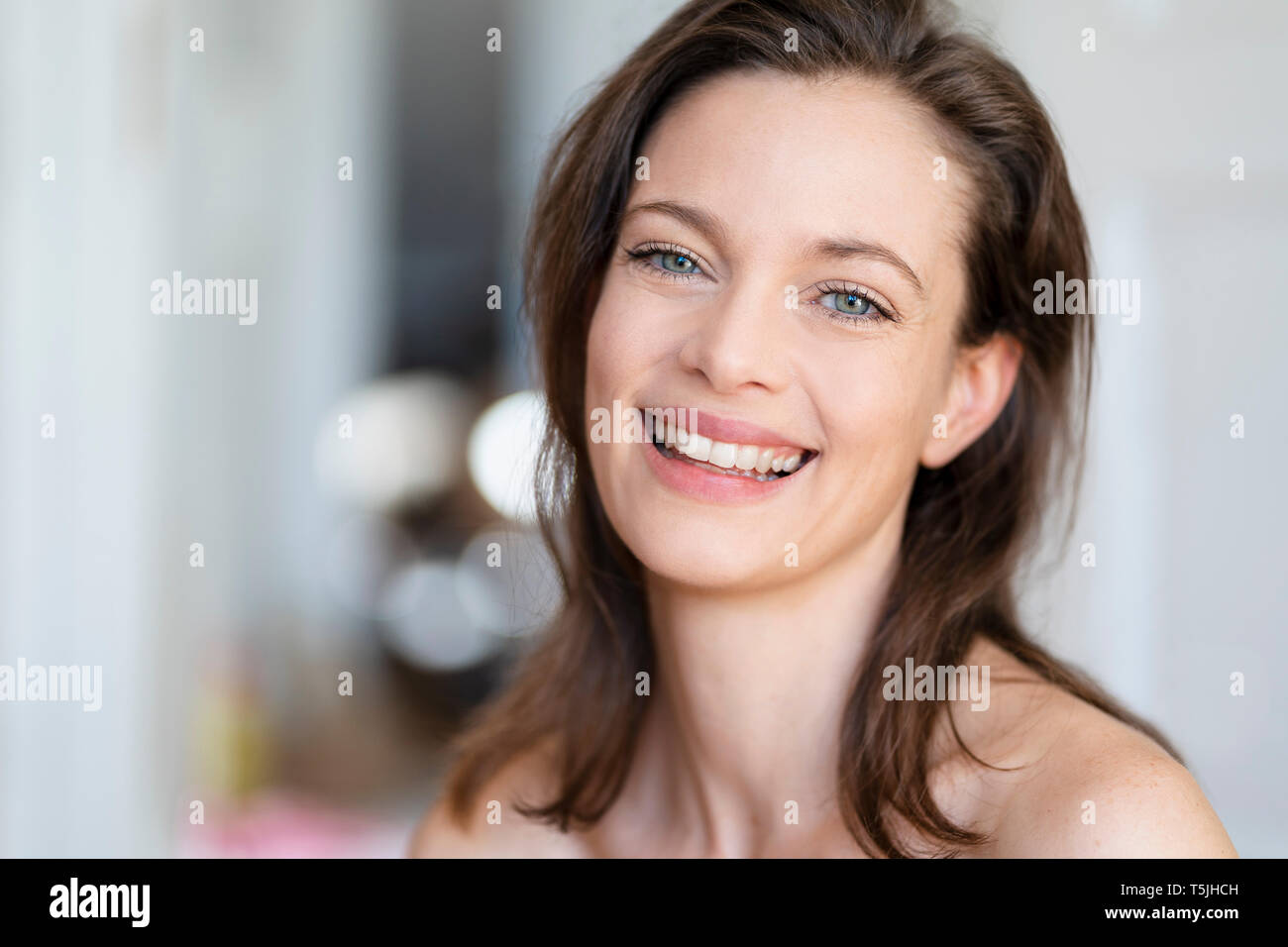 Portrait of laughing woman with brown hair Stock Photo - Alamy