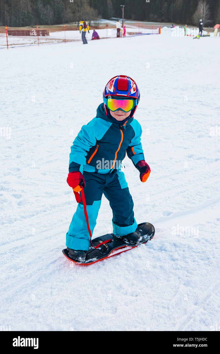 Italy, Trentino-Alto Adige, boy riding on small snowboard on piste Stock  Photo - Alamy