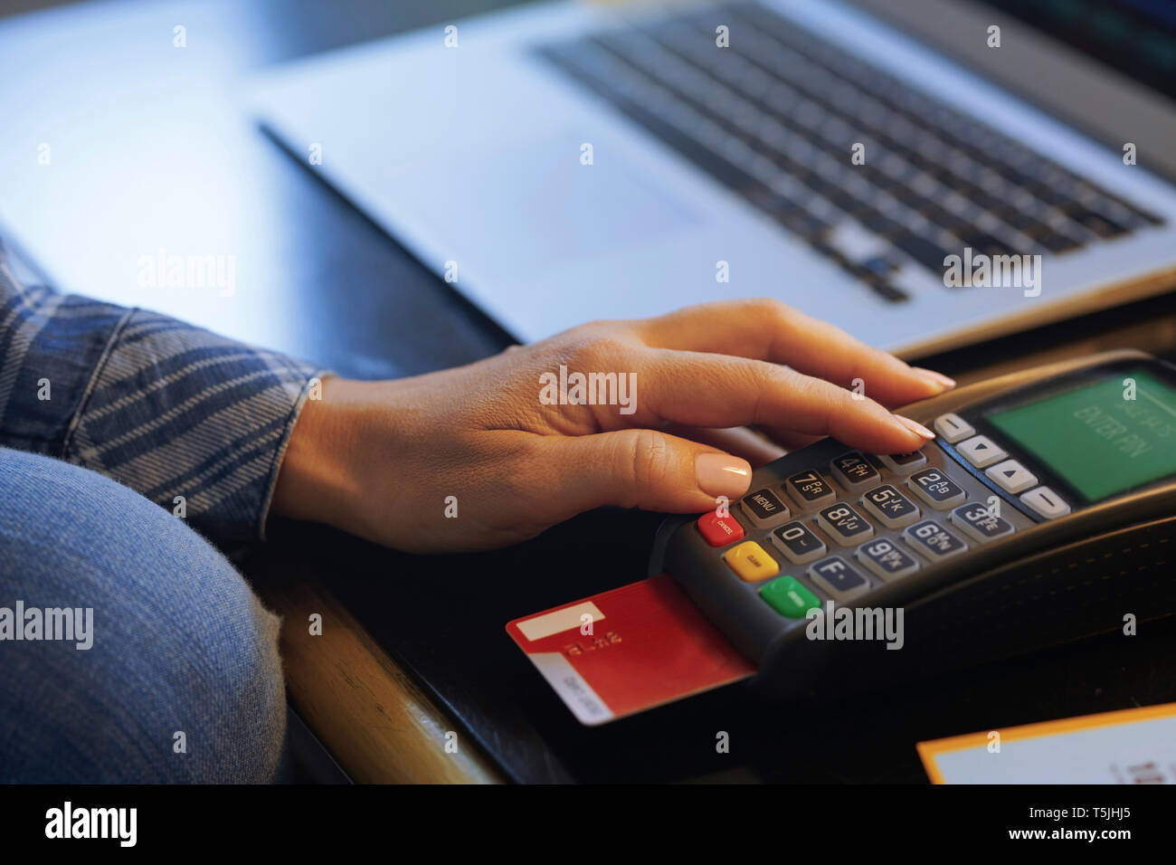 Woman with laptop using online banking, close-up Stock Photo