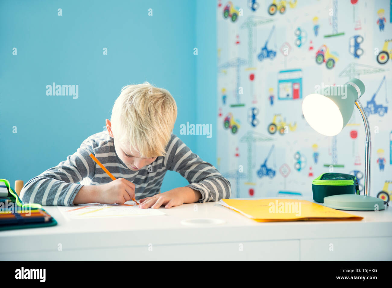 Focused Boy Doing Homework At Desk In Children S Room Stock Photo