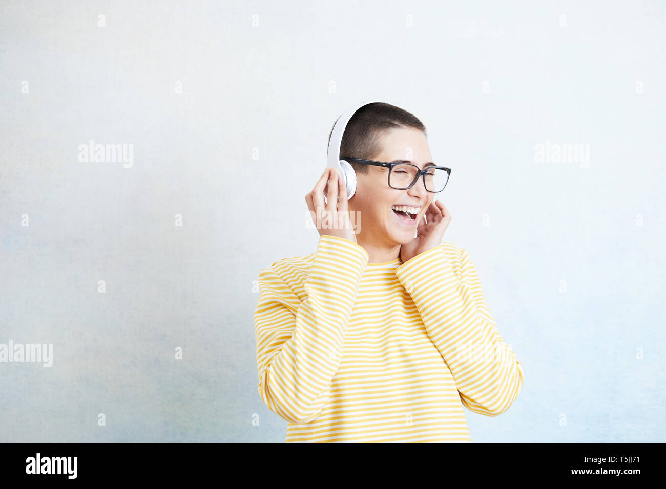 Happy young woman listening music with headphones Stock Photo