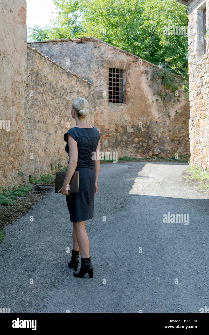 Woman laptop walking village hi-res stock photography and images - Alamy