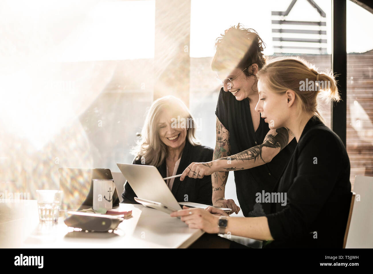 Creative businesswomen working together in office Stock Photo - Alamy