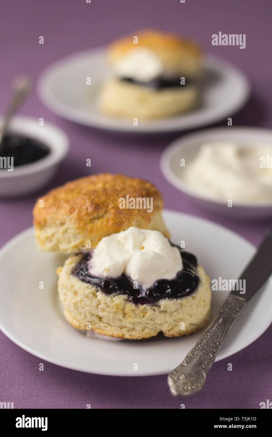 Traditional English freshly baked scones with jam and cream Stock Photo