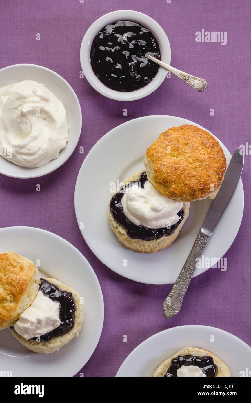 Traditional English freshly baked scones with jam and cream Stock Photo