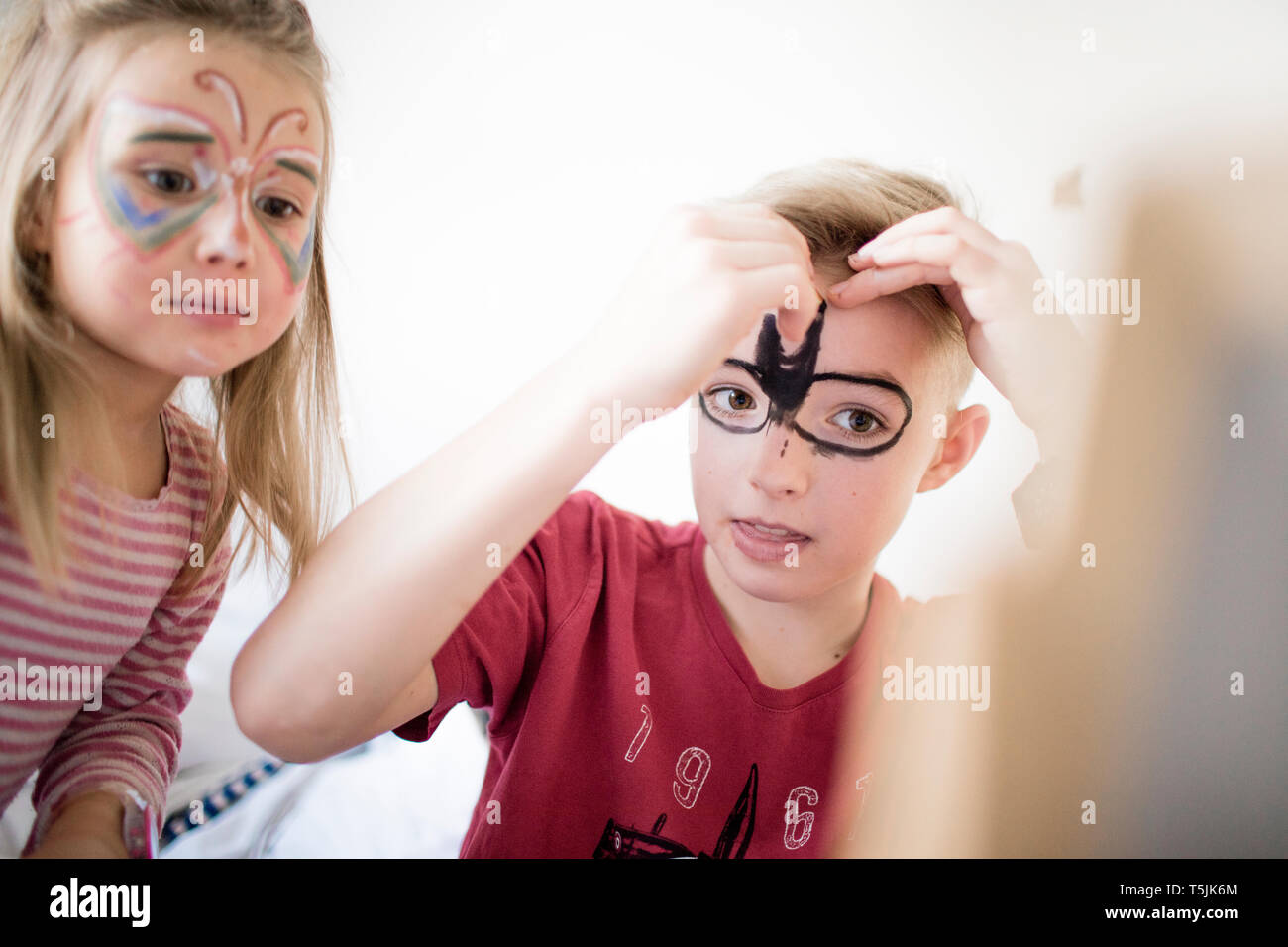 Brother and sister preparing for carneval Stock Photo