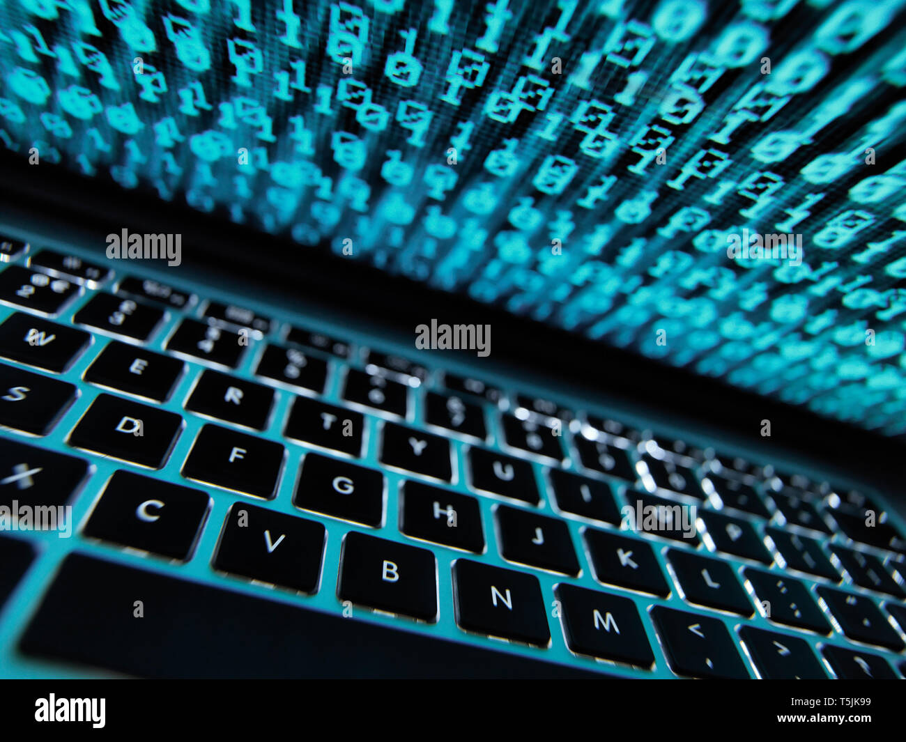Computer virus infecting a laptop computer with a virus Stock Photo