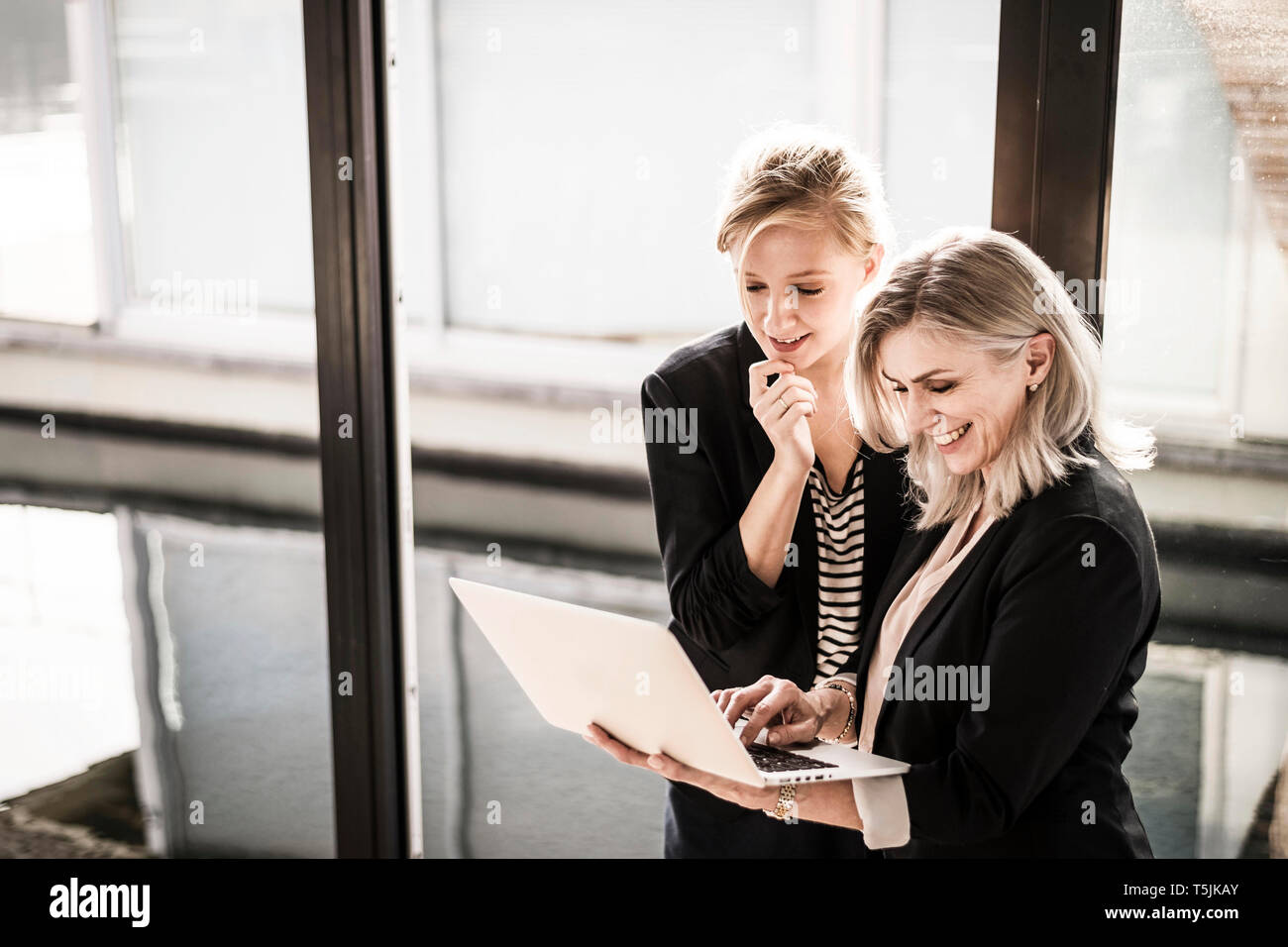 Creative businesswomen working together in office Stock Photo - Alamy