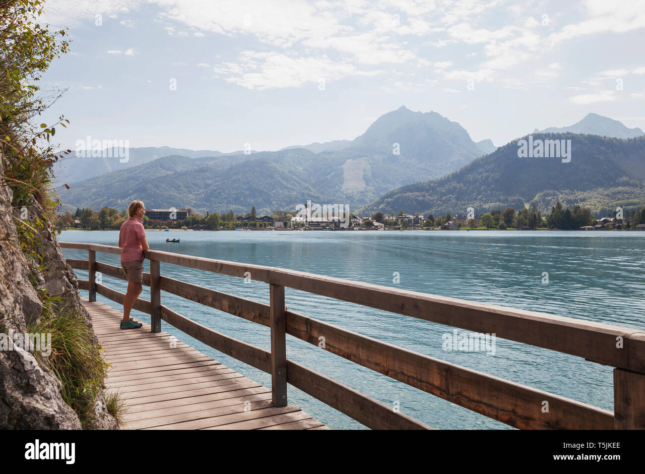 Austria, Alps, Salzburg, Salzkammergut, Salzburger Land, Wolfgangsee, woman enjoying view Stock Photo