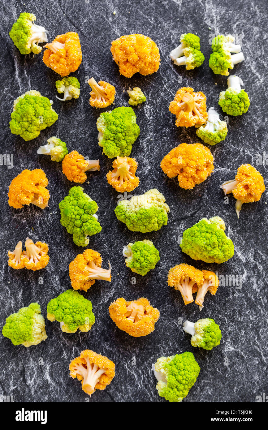 Yellow and bright green cauliflower florets on slate Stock Photo