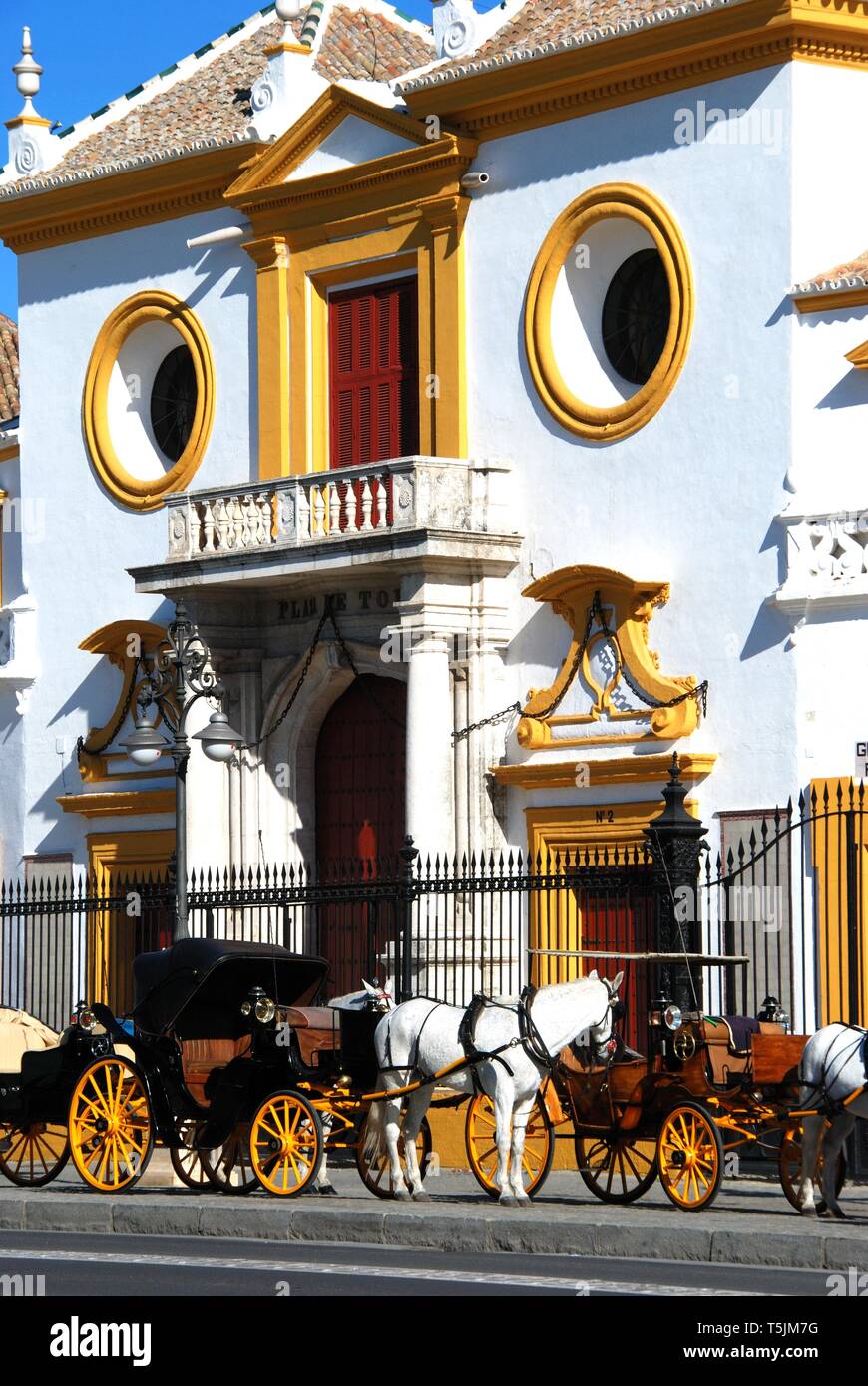 View of the bullring with horse drawn carriages in the foreground