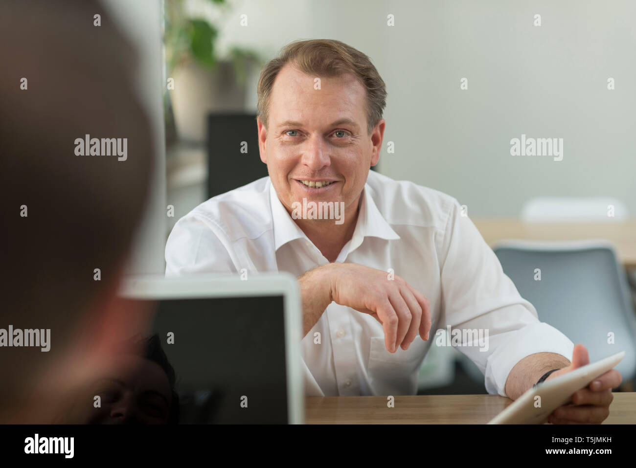 Two businessmen working with tablet in office Stock Photo