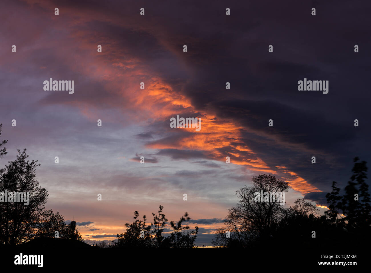 Dramatic beautiful colored cloudy sky at sunset Stock Photo