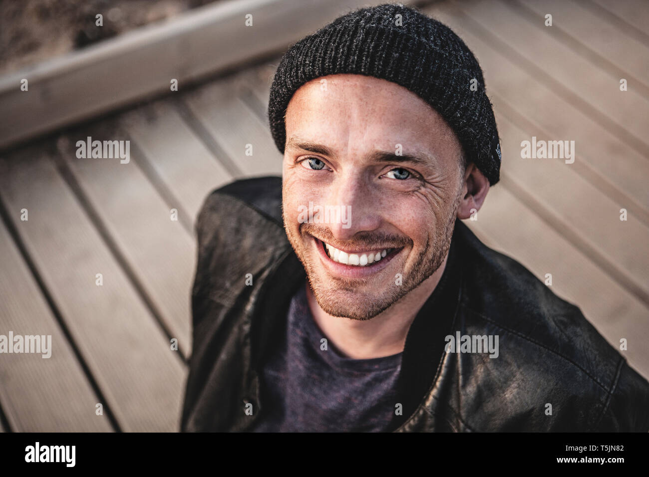 Portrait of smiling man with stubble wearing woolly hat Stock Photo