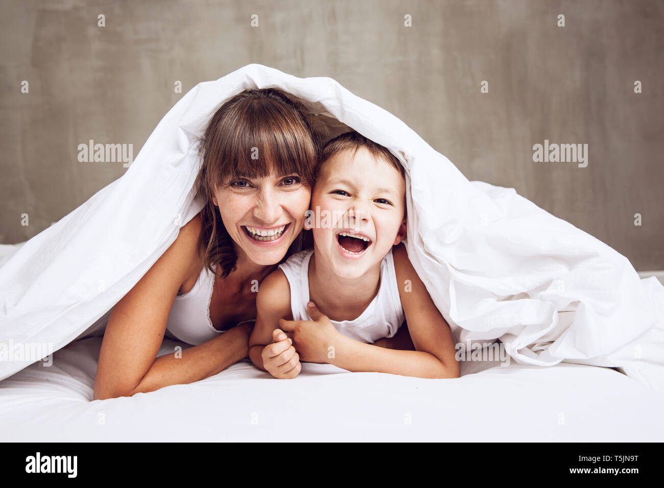 Mother And Son Cuddling Under Blanket Laughing Stock Photo Alamy