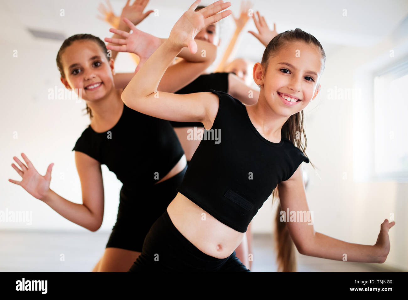 Group of young girls practicing and exercising modern ballet dance. Stock Photo