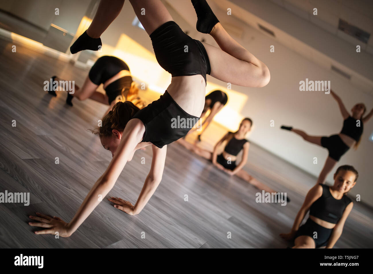 Group of young girls practicing and exercising modern ballet dance. Stock Photo