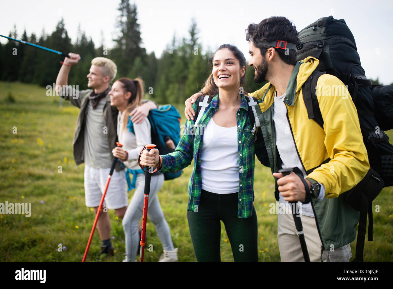 Group of young friends hiking in countryside. Multiracial young people ...