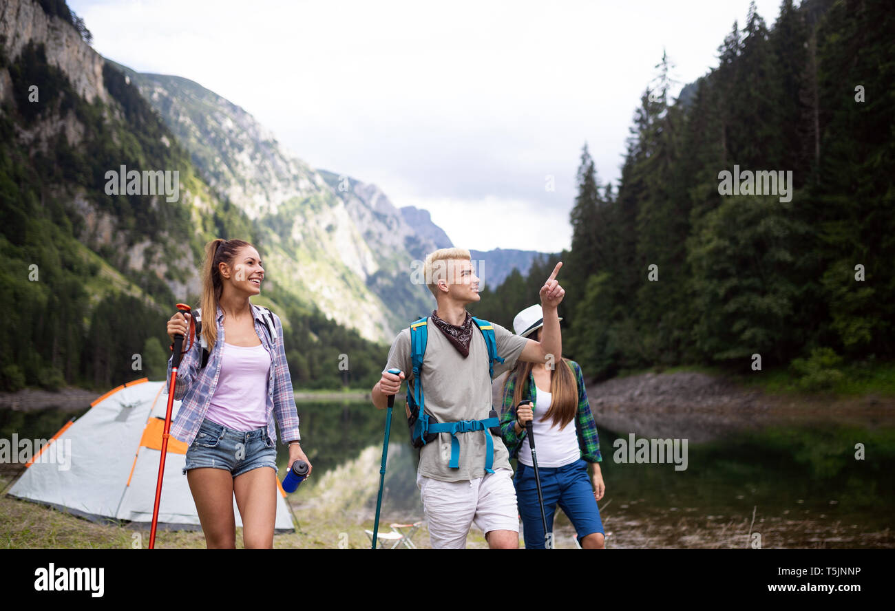Group of friends hikers walking on a mountain at sunset Stock Photo - Alamy