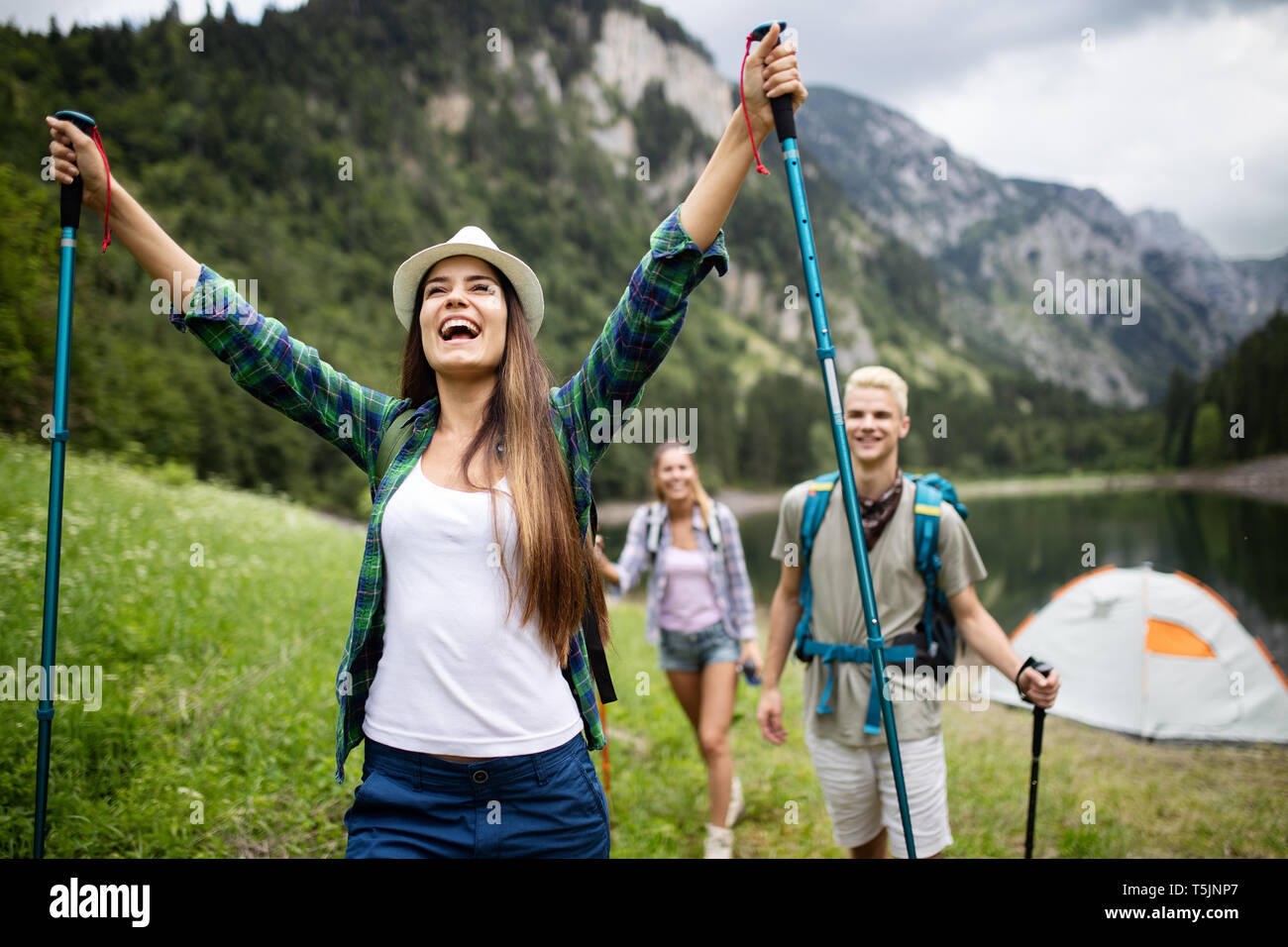 Group of friends hikers walking on a mountain at sunset Stock Photo - Alamy