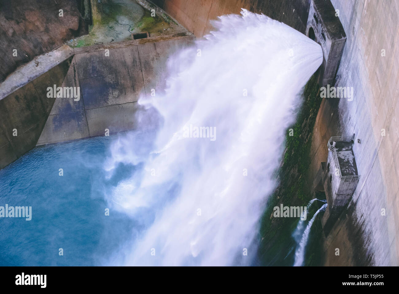 massive volume of water falling from dam gates Stock Photo - Alamy