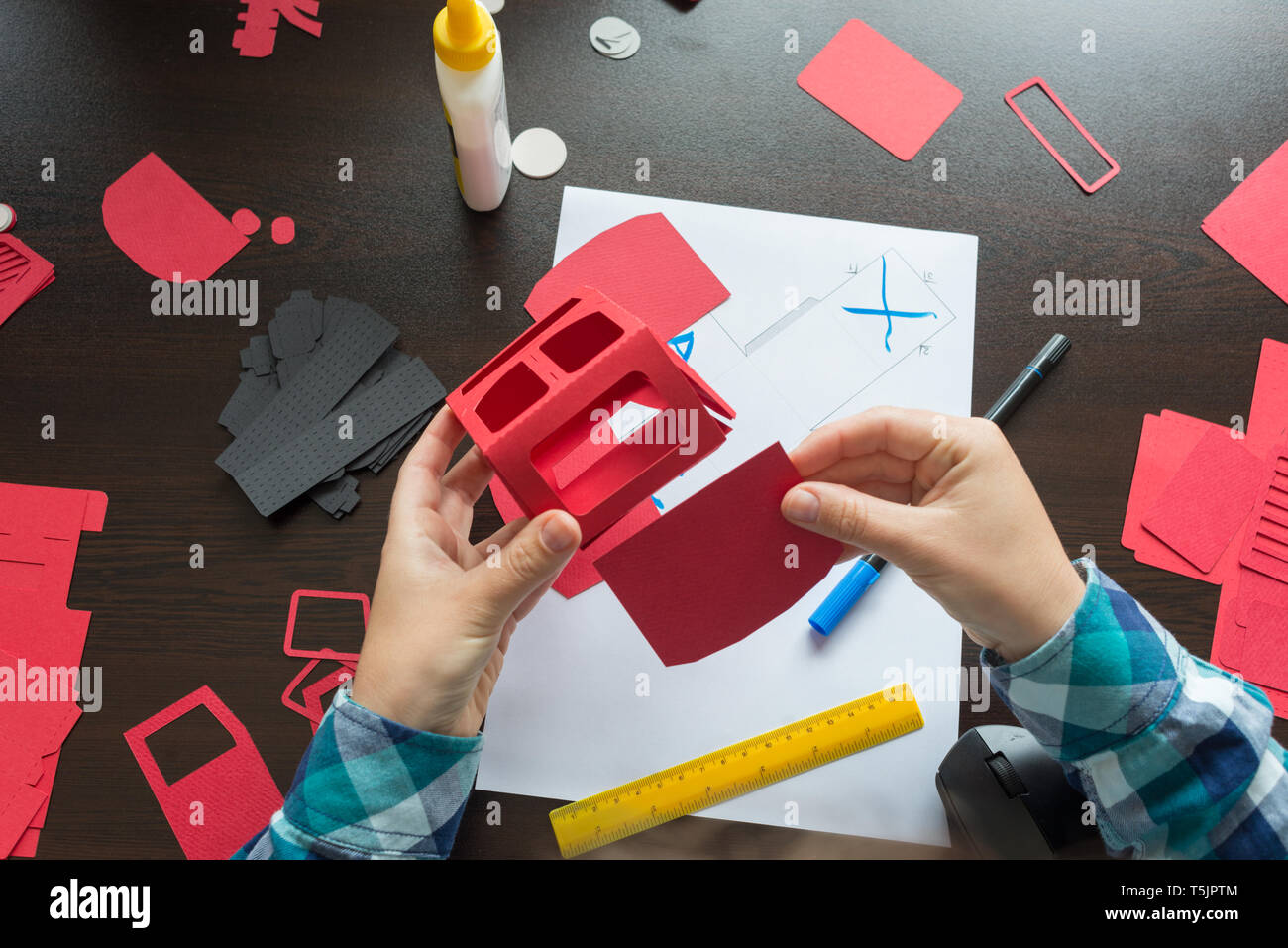 designer working with paper modeling craft template Stock Photo