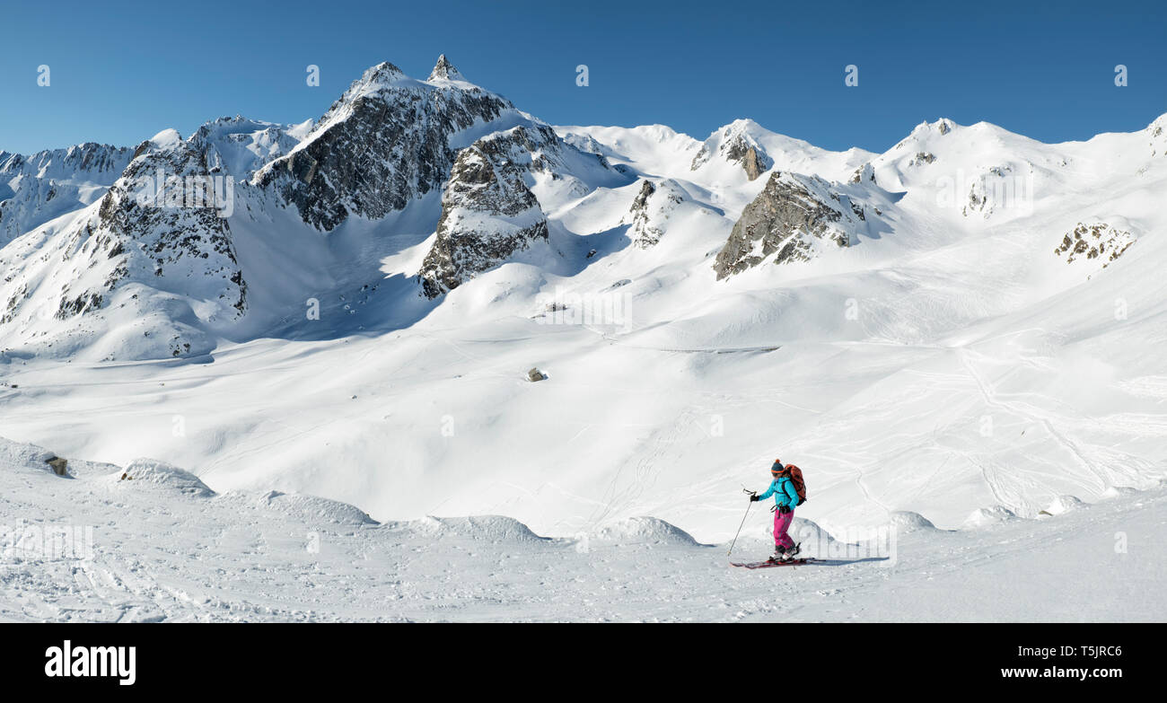 Switzerland, Grand Saint Bernard Pass, Pain de Sucre, Mont Fourchon, woman ski touring in the mountains Stock Photo