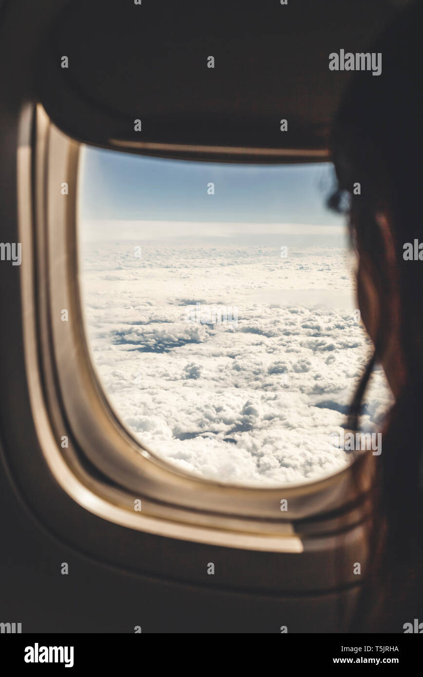 Argentina, Santa Fe, Rosario, woman looking through plane window Stock Photo