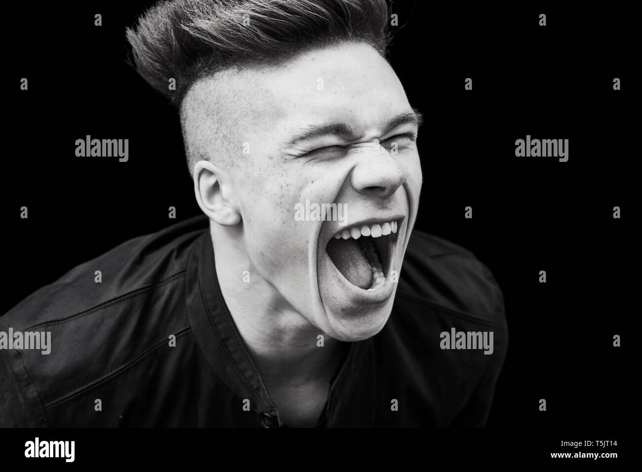 Black and white portrait of young man screaming Stock Photo