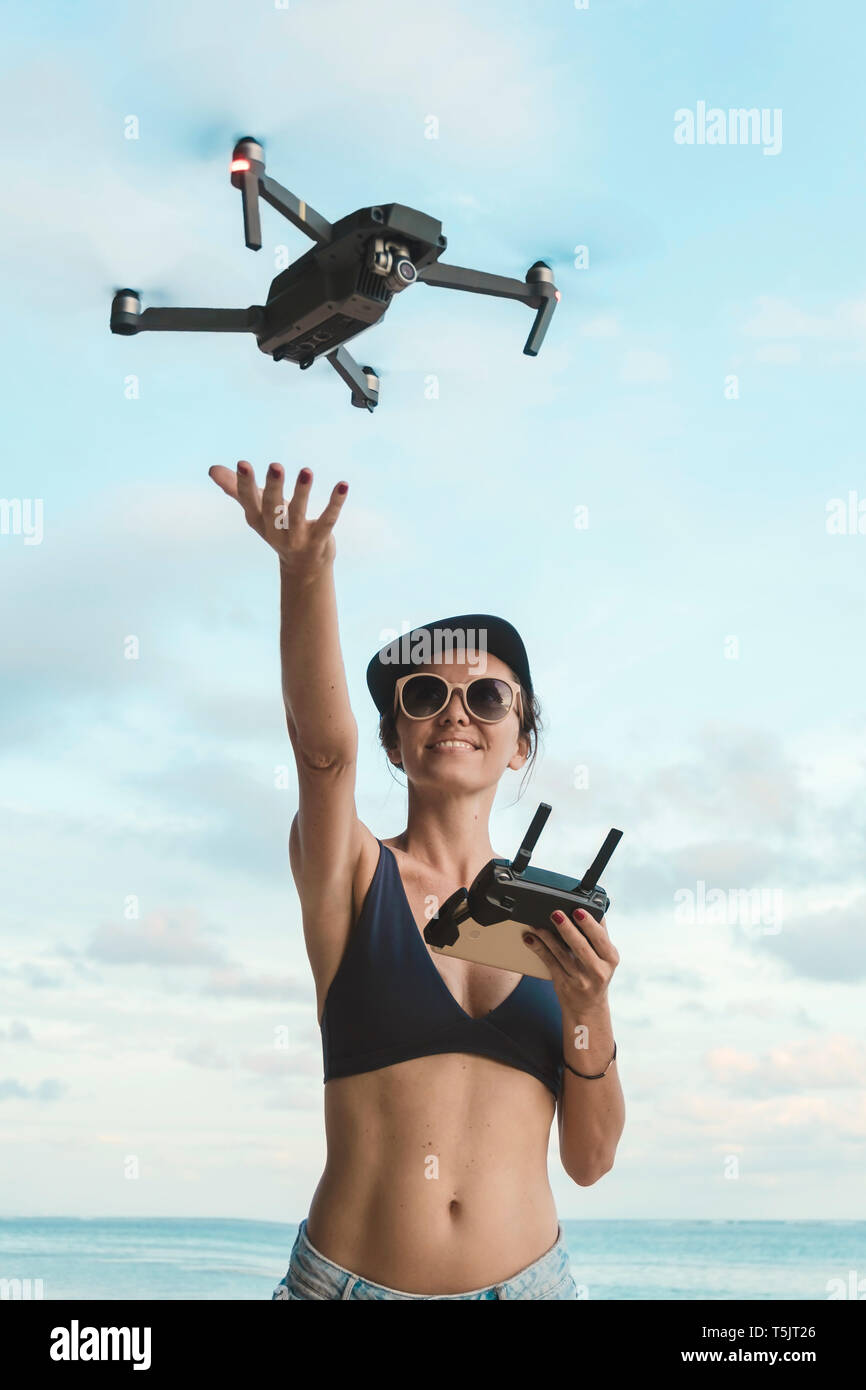 Woman flying drone beach hi-res stock photography and images - Alamy