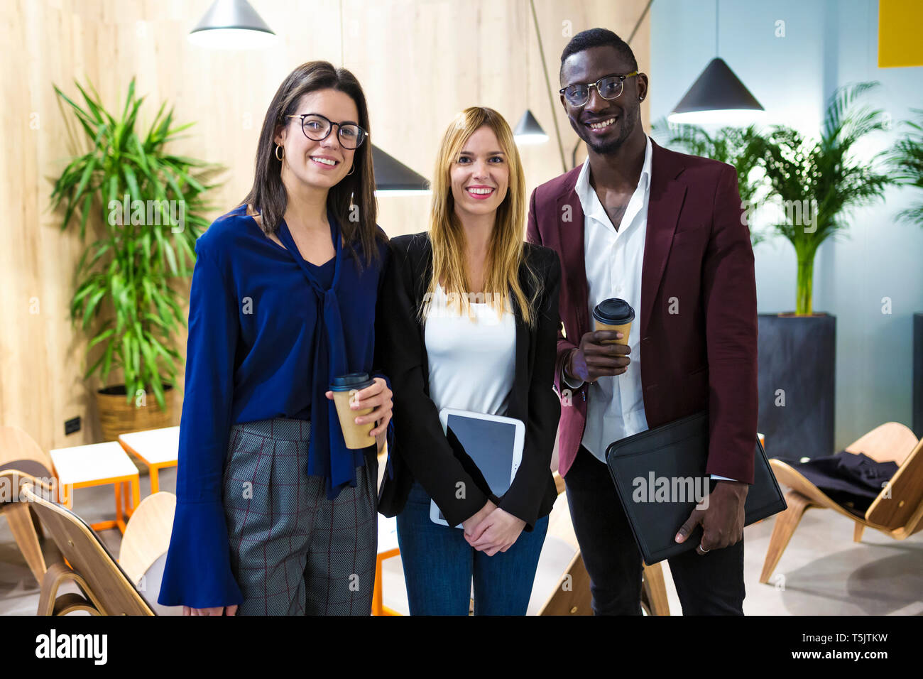 Business people standing in hotel lobby, smiling Stock Photo - Alamy