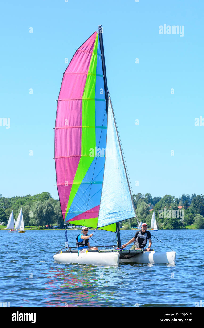 Catamaran sailing on inland lake in summertime Stock Photo