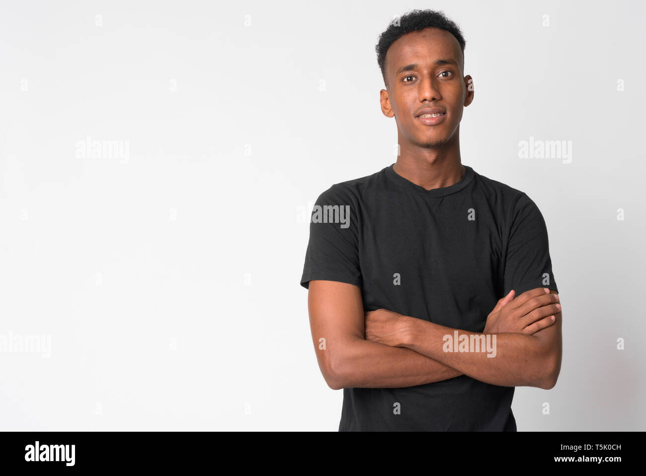 Portrait of young happy African man smiling with arms crossed Stock ...
