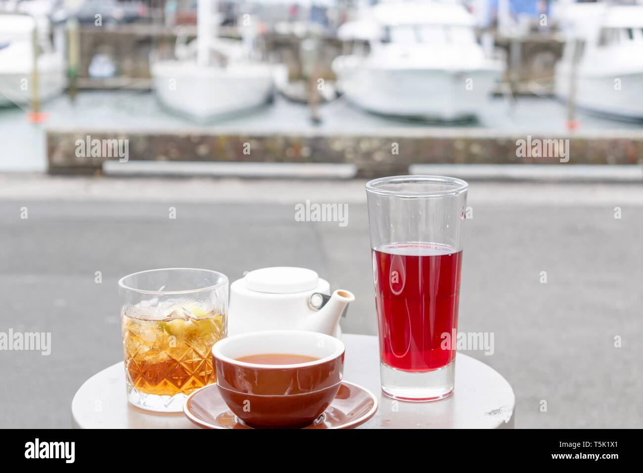 Tea served on a small round table in a selection of containers cups
