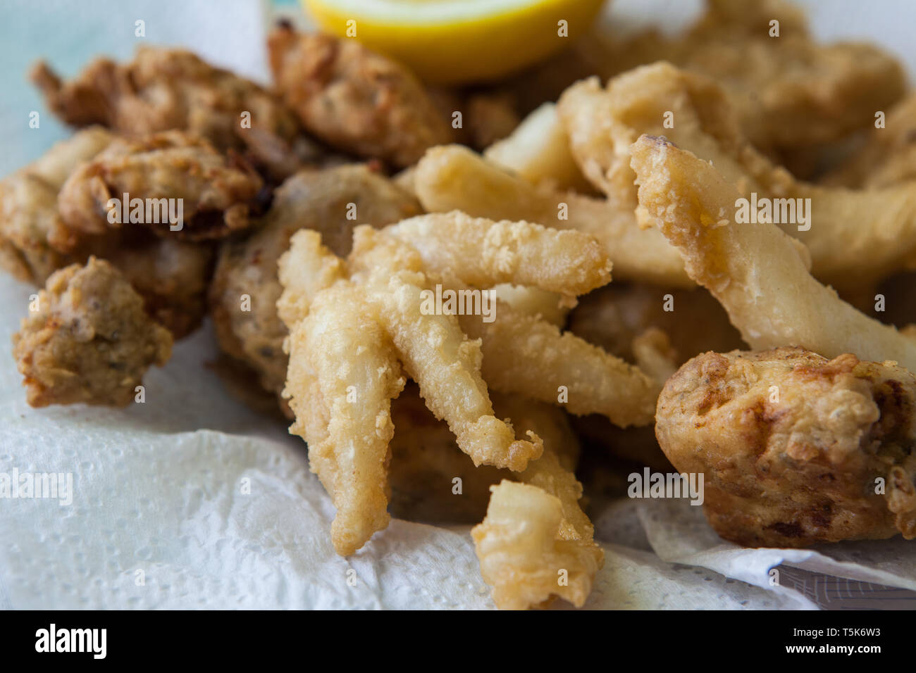 deep fried squid and fish on olive oil with lemon Stock Photo