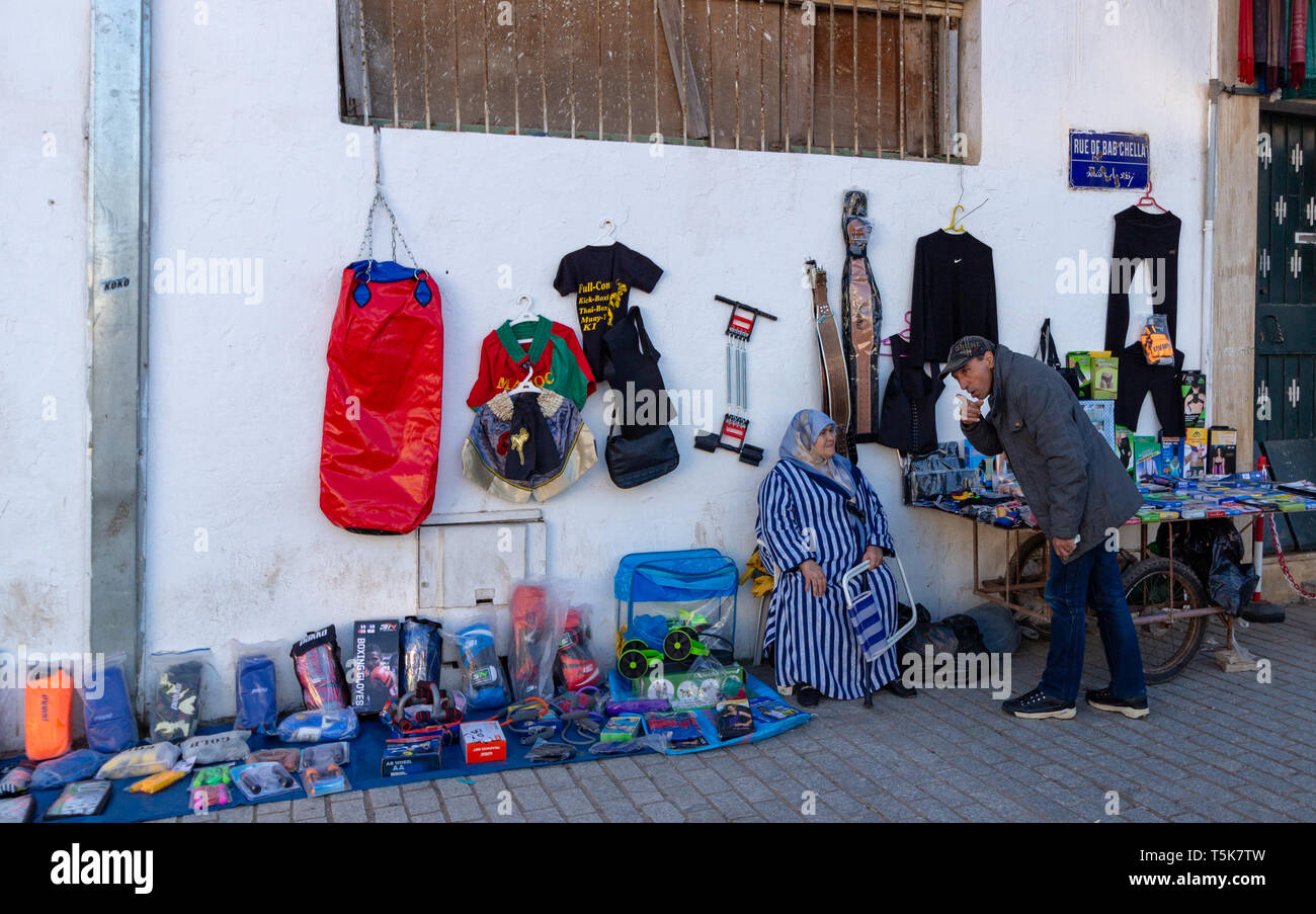 Medina of Rabat Souk, Rabat, Morocco, April 24 2019. A market seller serving a customer and selling goods on the street in Rabat at the entrance to th Stock Photo