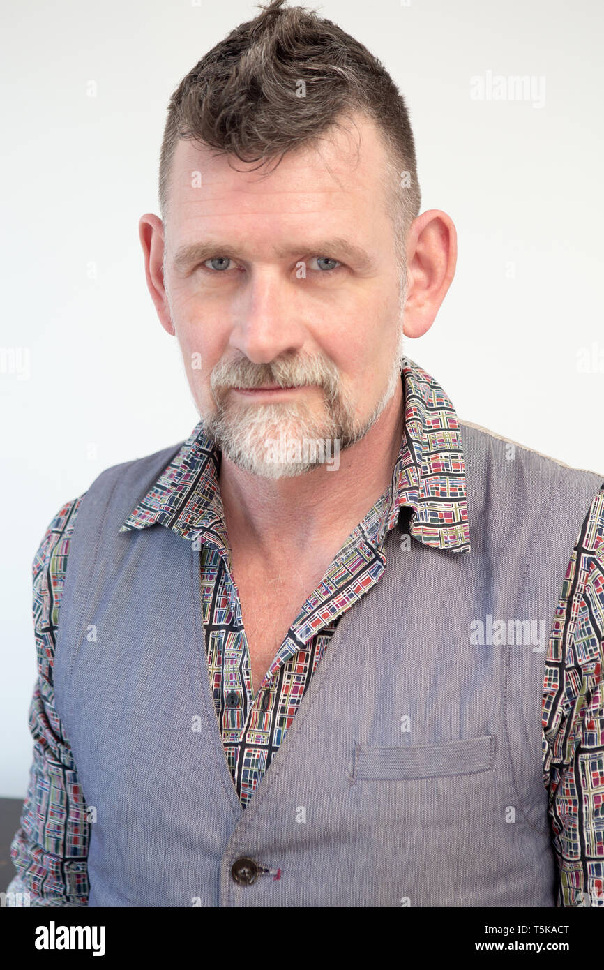 Portrait Of Smiling Handsome Grey Haired Man In His 50s Stock