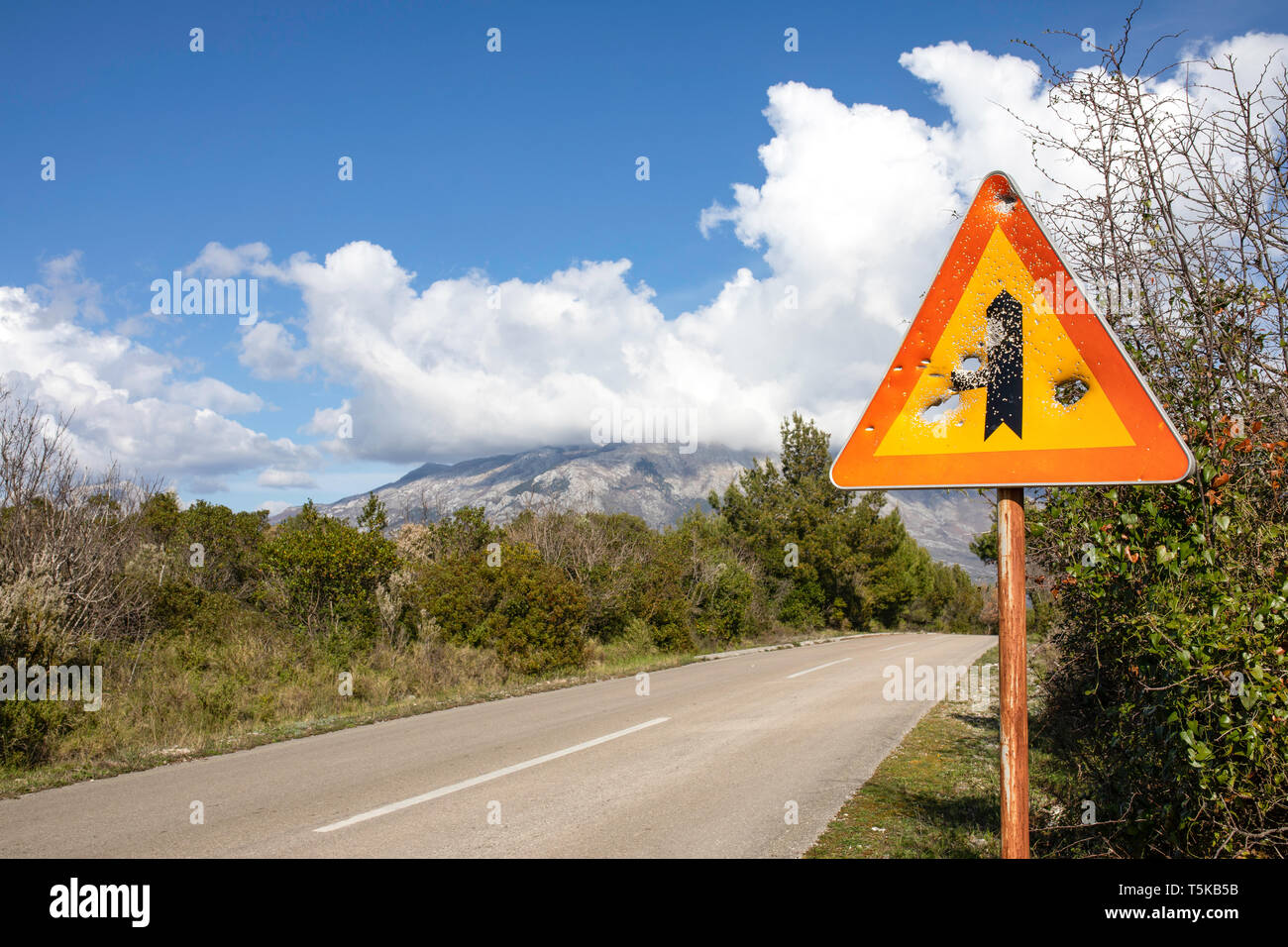 Shoot street sign, wholes after shooting. Mountain road in Montenegro. Stock Photo