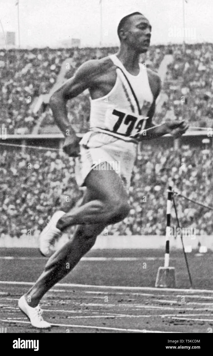 JESSE OWENS (1913-1980) American athlete winning the 100 m race at the 1936 Berlin Summer Olympics on 3 August. Stock Photo