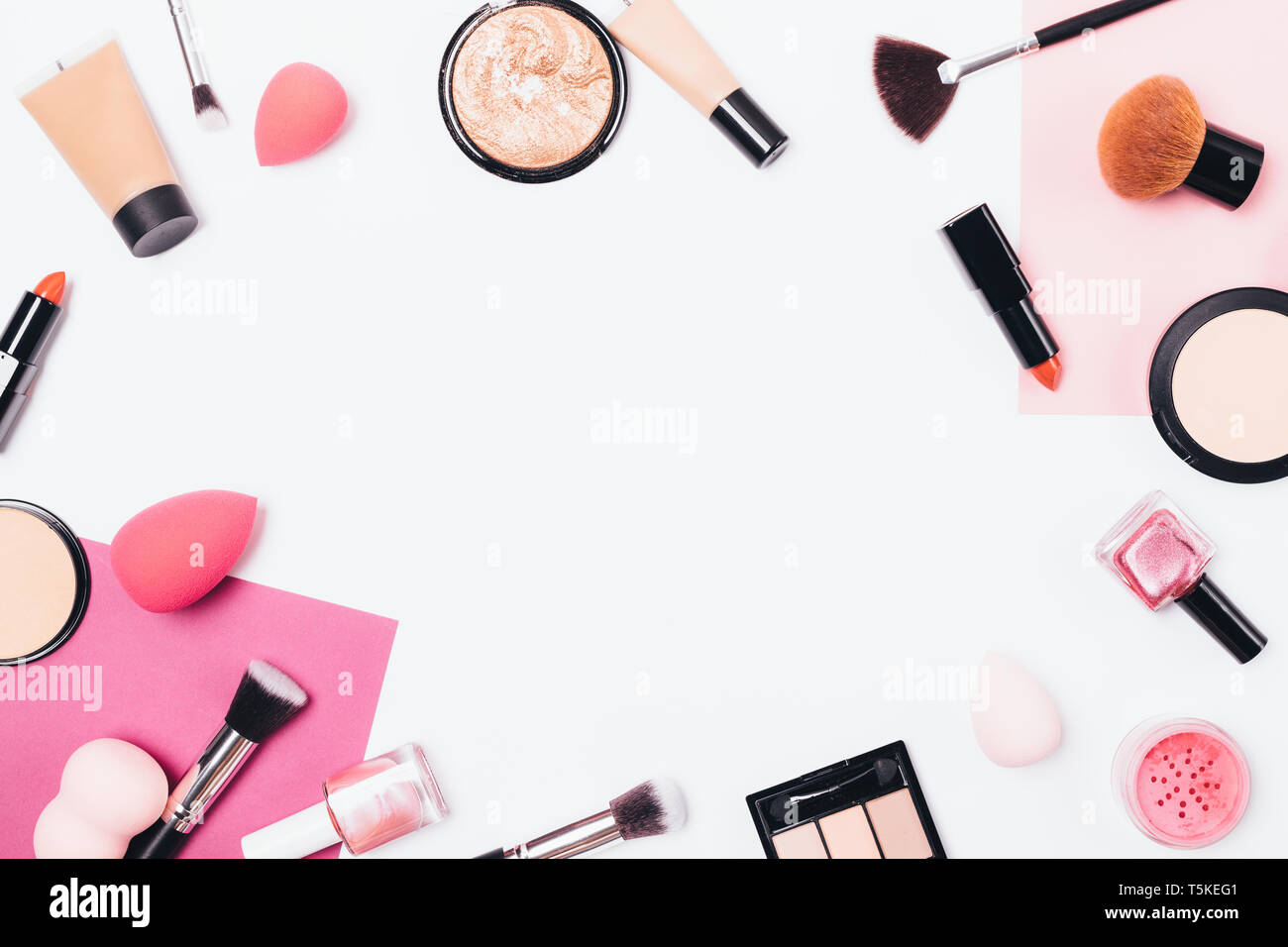Flat lay makeup background frame of professional cosmetic products and  accessories on white table, top view Stock Photo - Alamy