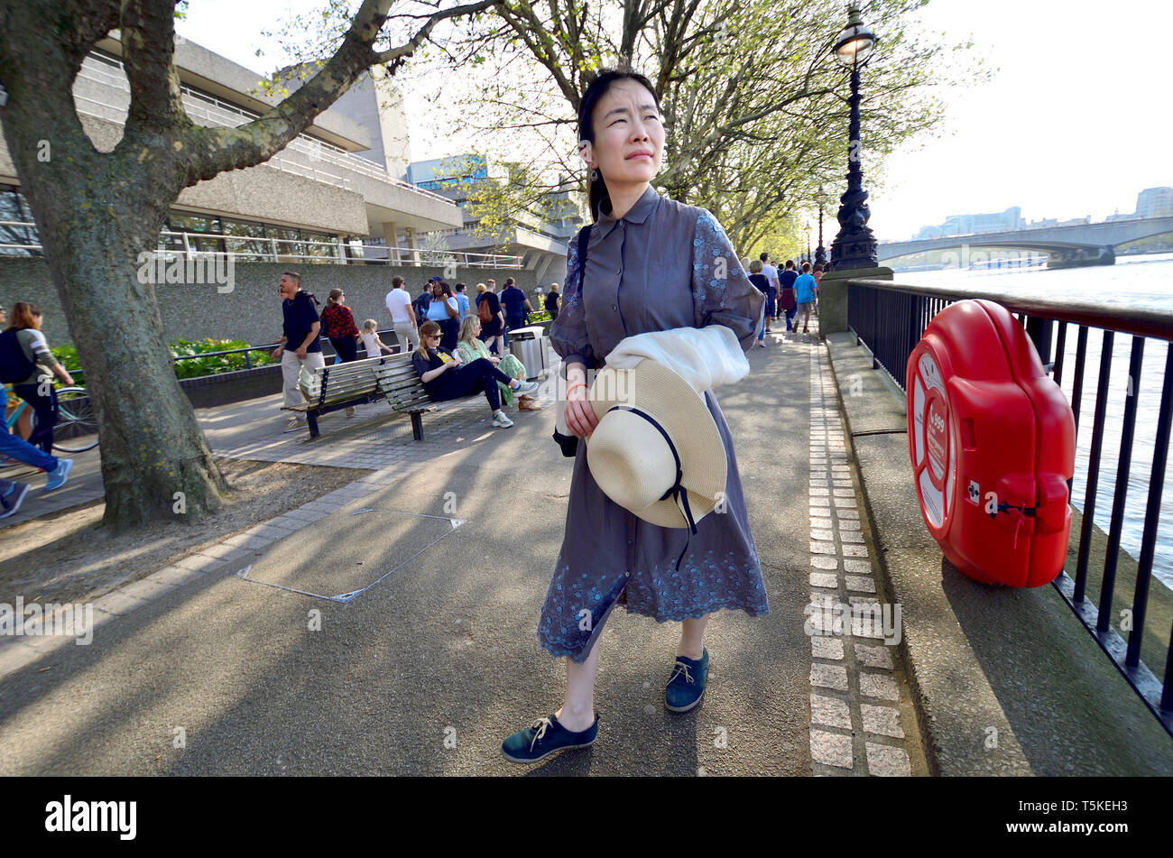 London, England, UK. Japanese woman on the South Bank, by the National Theatre Stock Photo